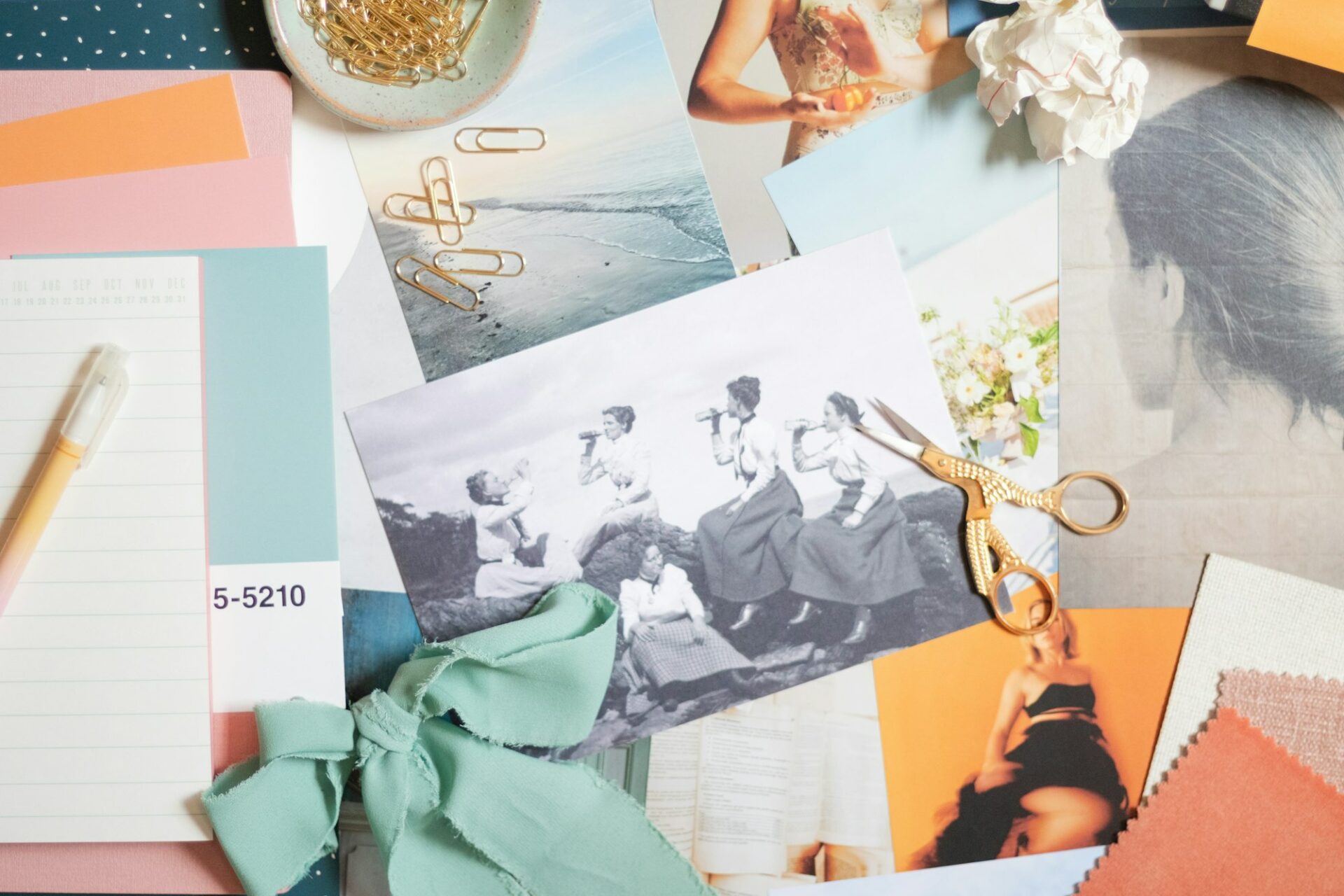 Images, découpages et ciseaux étalés sur une table pour composer une planche d’inspiration