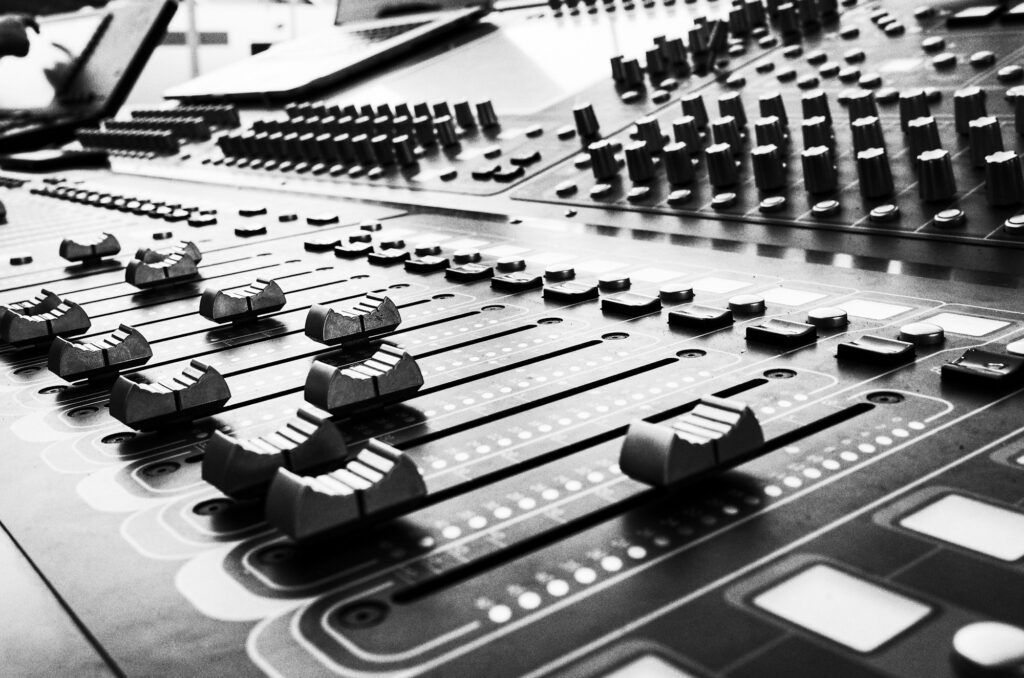 Gros plan sur les potentiomètres d’une console de mixage en studio