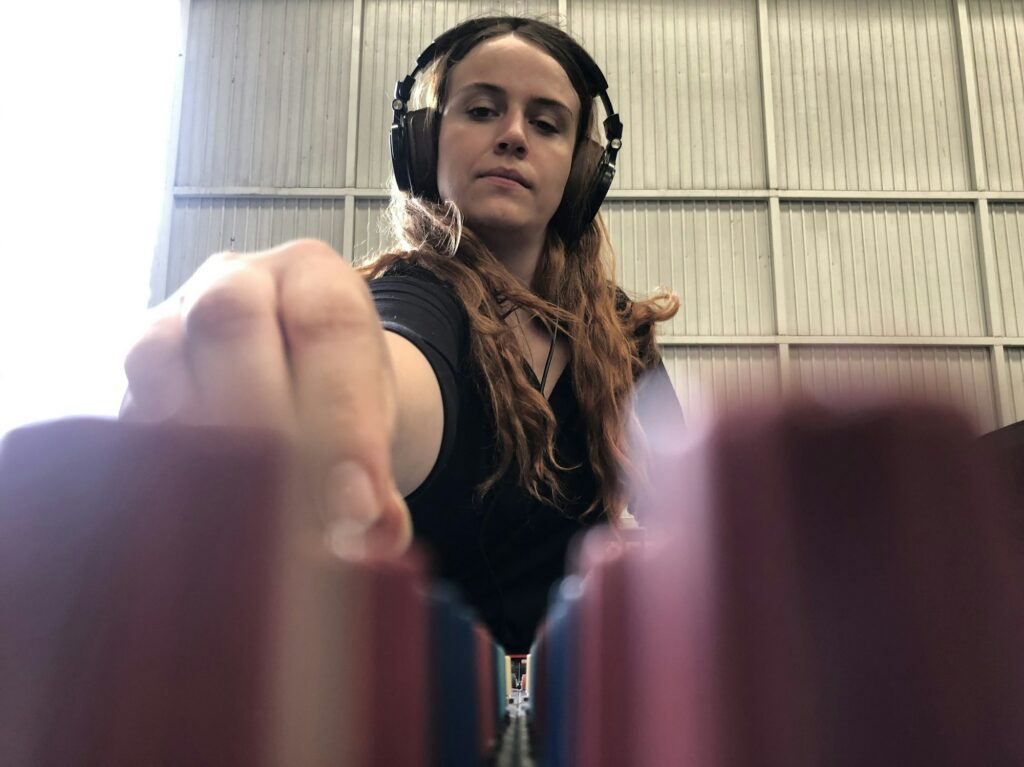 Ingénieure du son travaillant à la console avec un casque