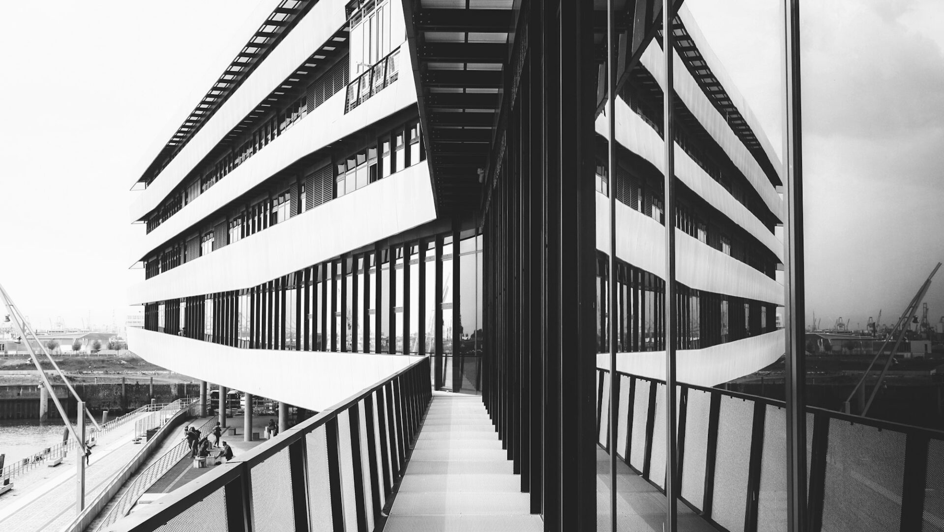 Immeubles se reflétant à l’identique dans une façade vitrée, en noir et blanc